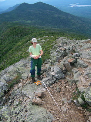 Photo: Image of an Ecologist working at Bigelow Preserve, and showing the view from West Peak