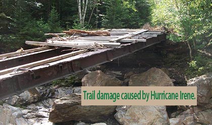 damage by Hurricane Irene to a trail bridge. Trees down, bridge boards missing.