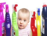 child surrounded by cleaning products