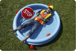 traffic control worker laying in kid's pool on a hot day