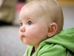 Young baby wearing a hearing aid
