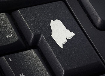 Black keyboard detail with imprint of Maine on enter key