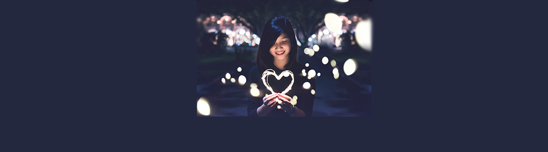 Person holding a heart that is lit up