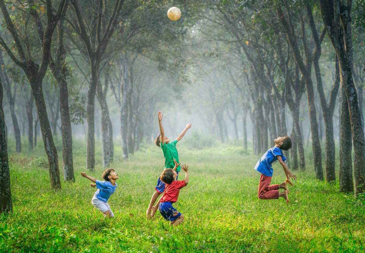 Four children playing with a ball