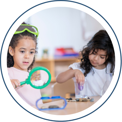 Students exploring with magnify glass