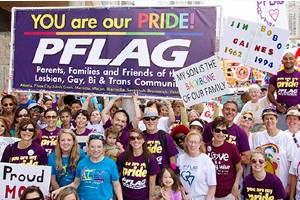 pride parade people holding rainbow flag portland maine