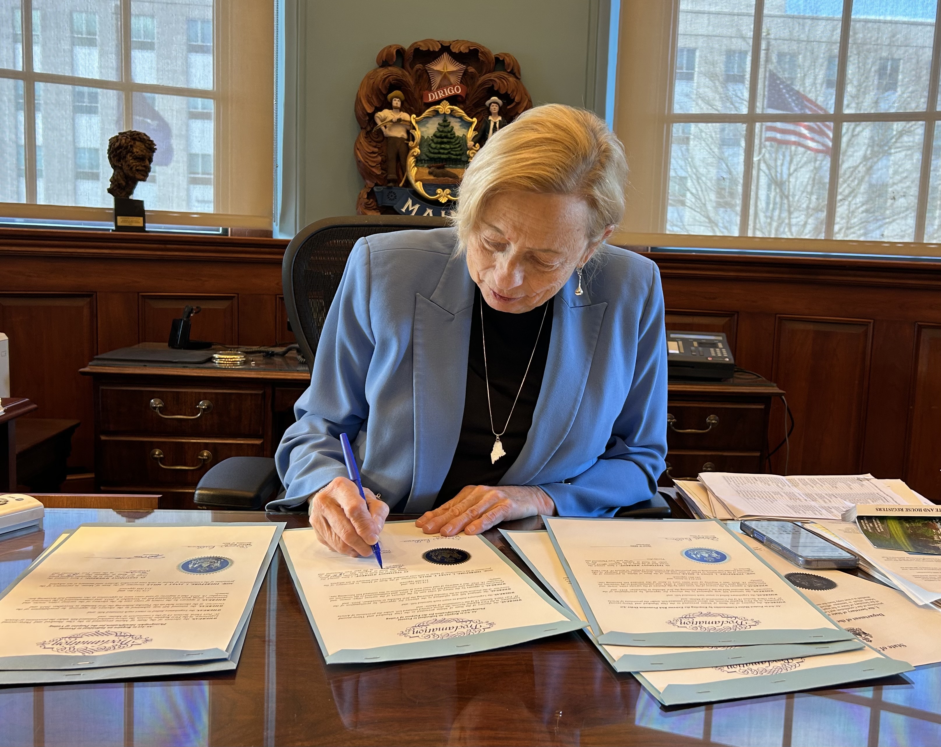 Governor Signing Documents on Desk