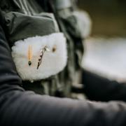 A close up of a fly angler's vest