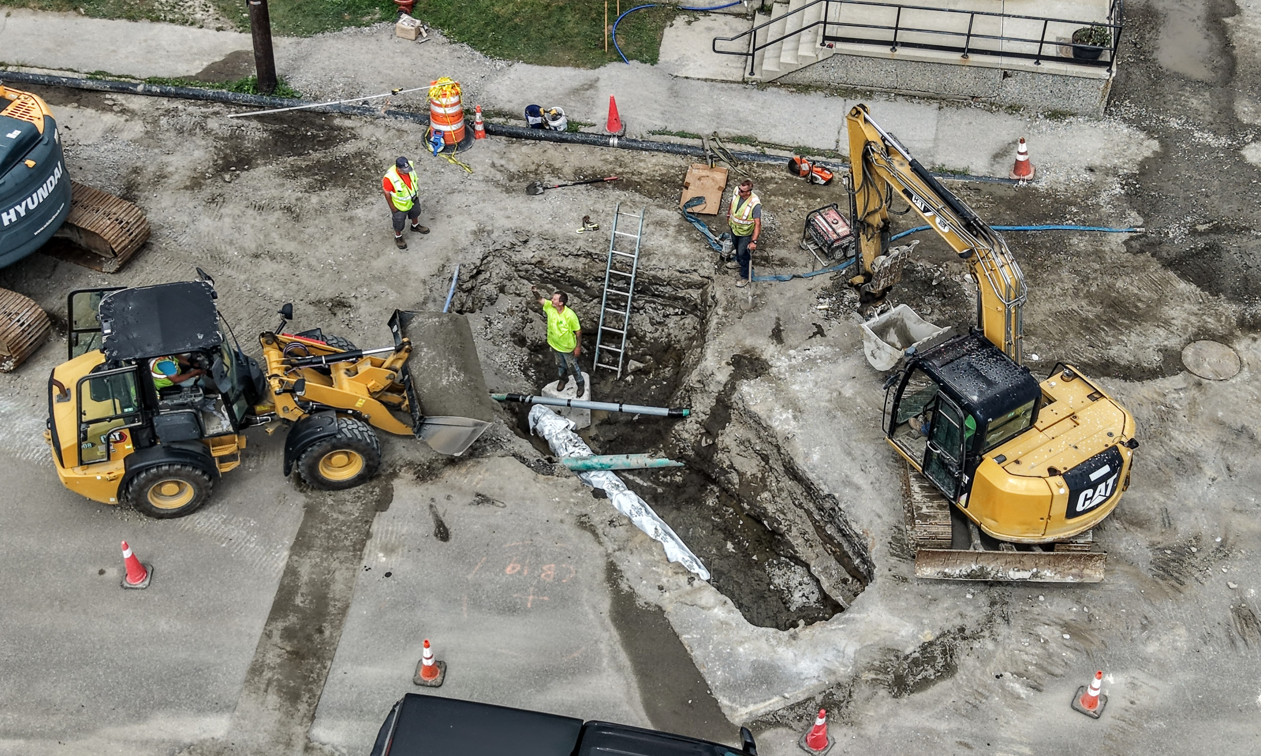 Aerial view of in-ground construction with excavators.