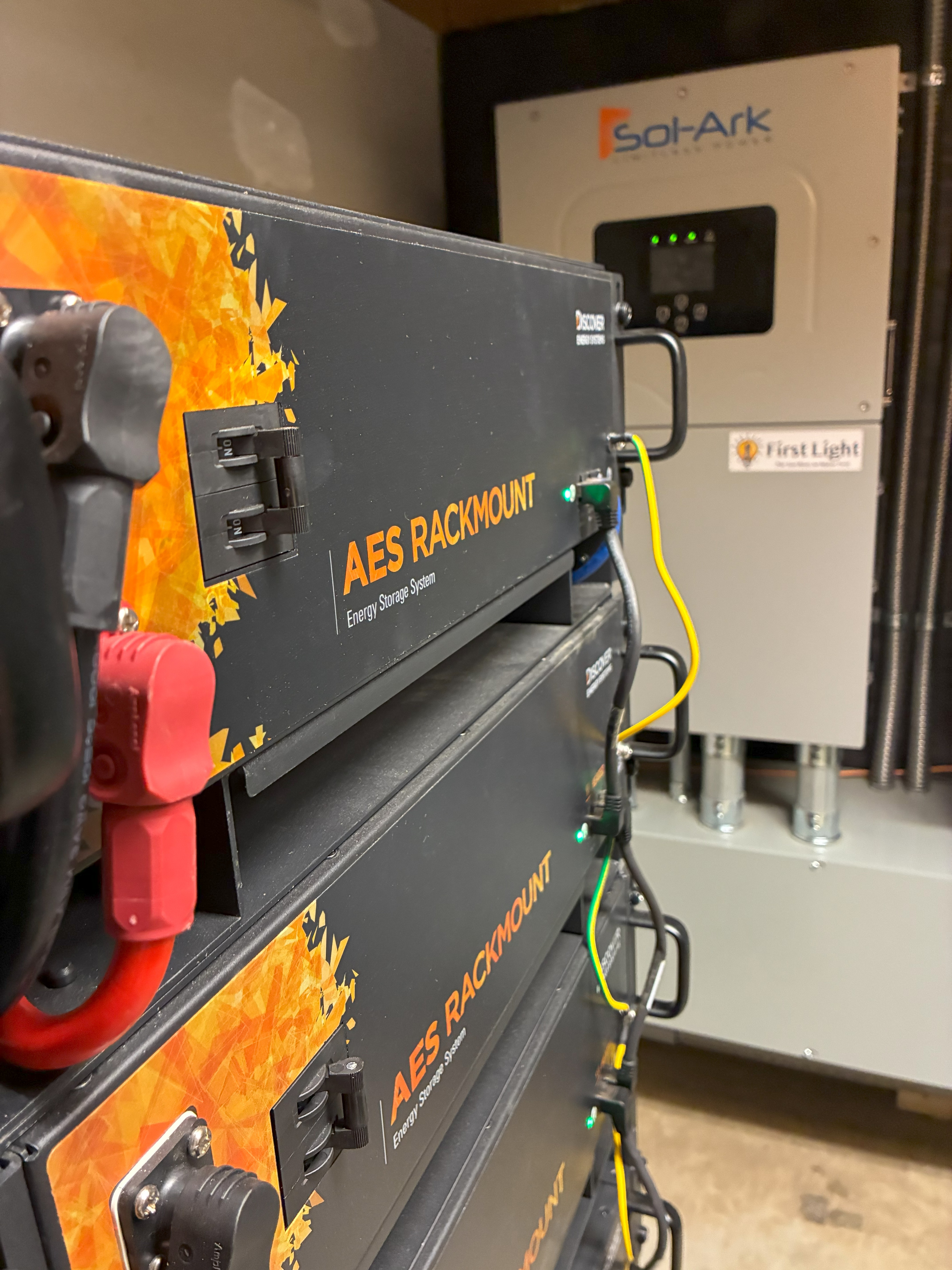 A stack of black batteries with an inverter. 